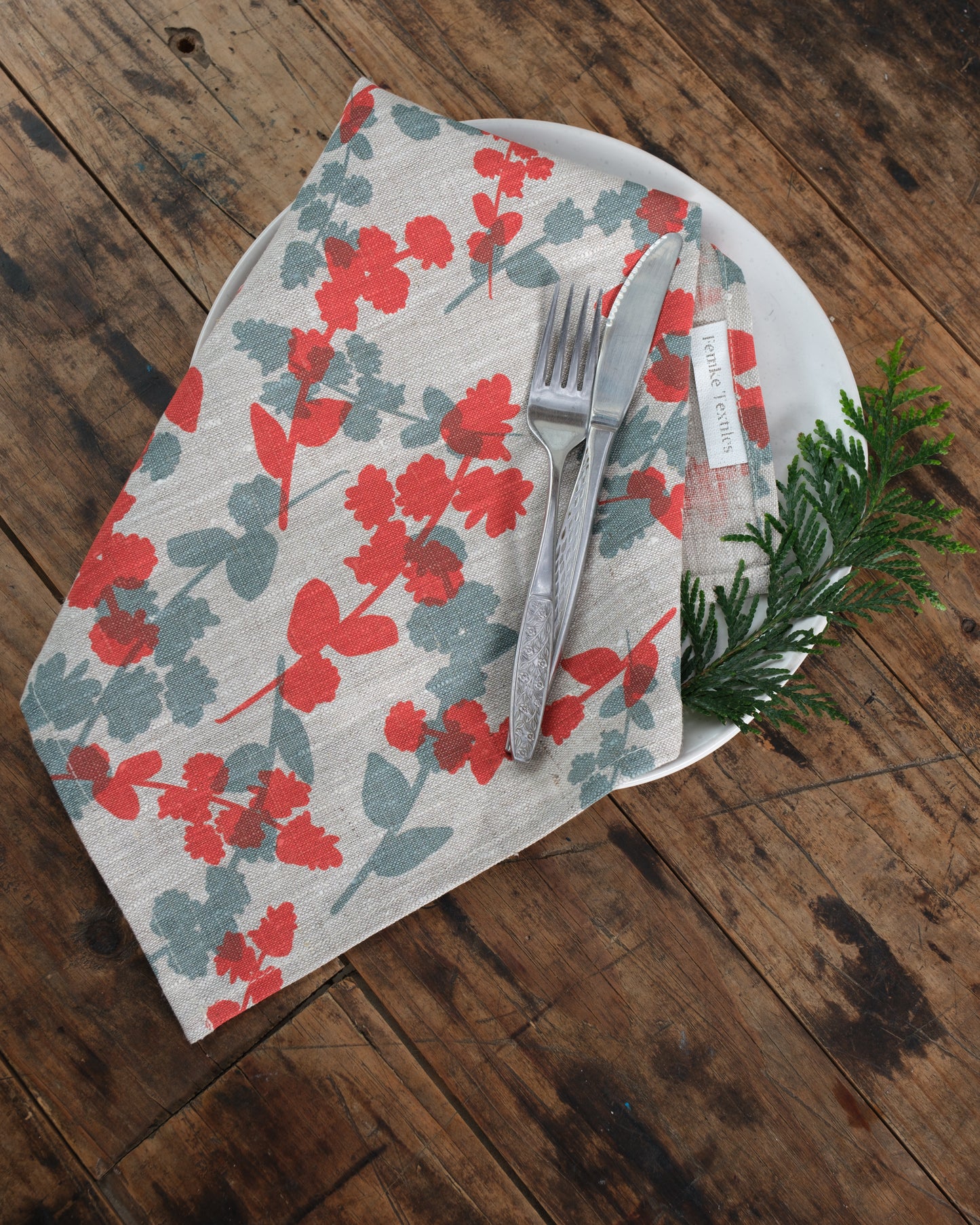 Linen napkins screen printed with Wattle Sprigs in Guava and Storm. Designed and screen printed by Femke Textiles.