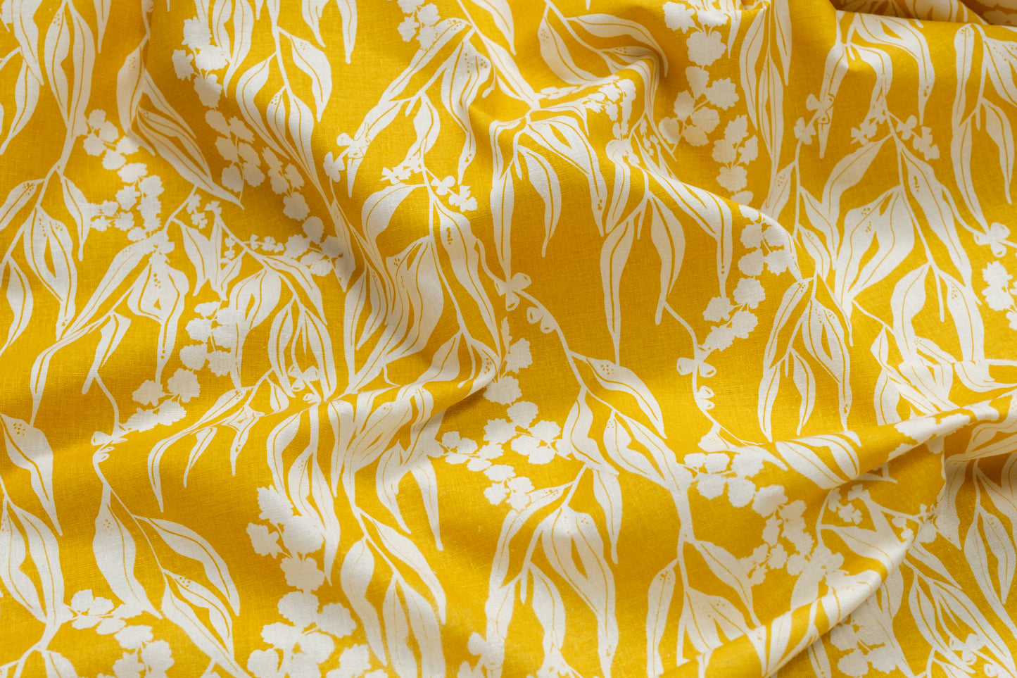 Organic cotton and hemp fabric screenprinted with pattern Nuts about Wattle in the colour Mustard. Designed and screenprinted in Melbourne by Femke Textiles.