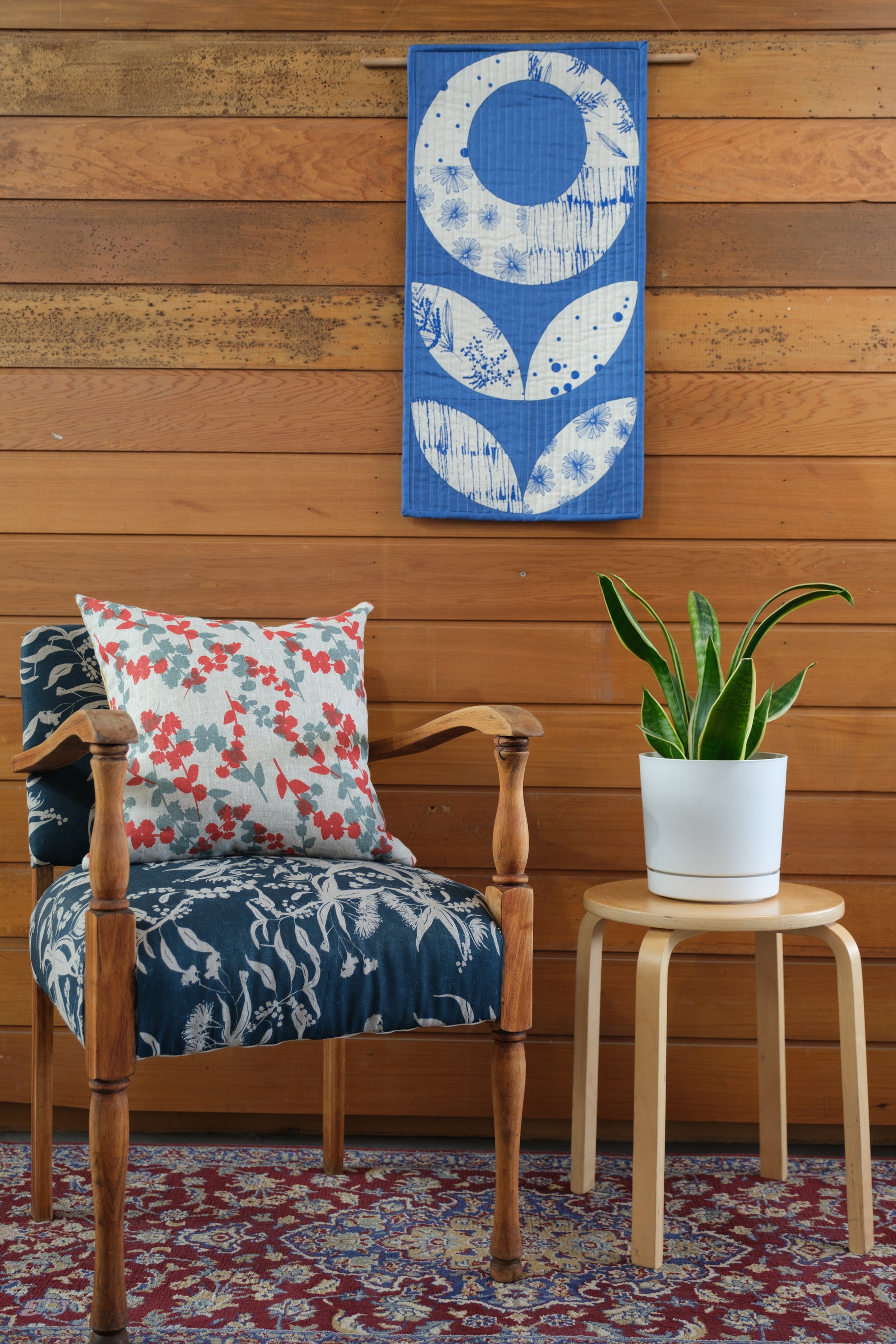 Single Poppy Wall hanging featuring fabric printed by Femke Textiles. Pattern for wall hanging designed by Stitch and Yarn.