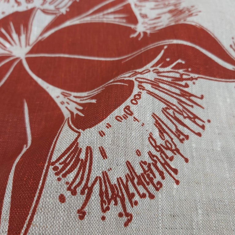 Image of hand screenprinted oatmeal linen with flying gumnut design in redwood. Designed and printed by Femke Textiles.