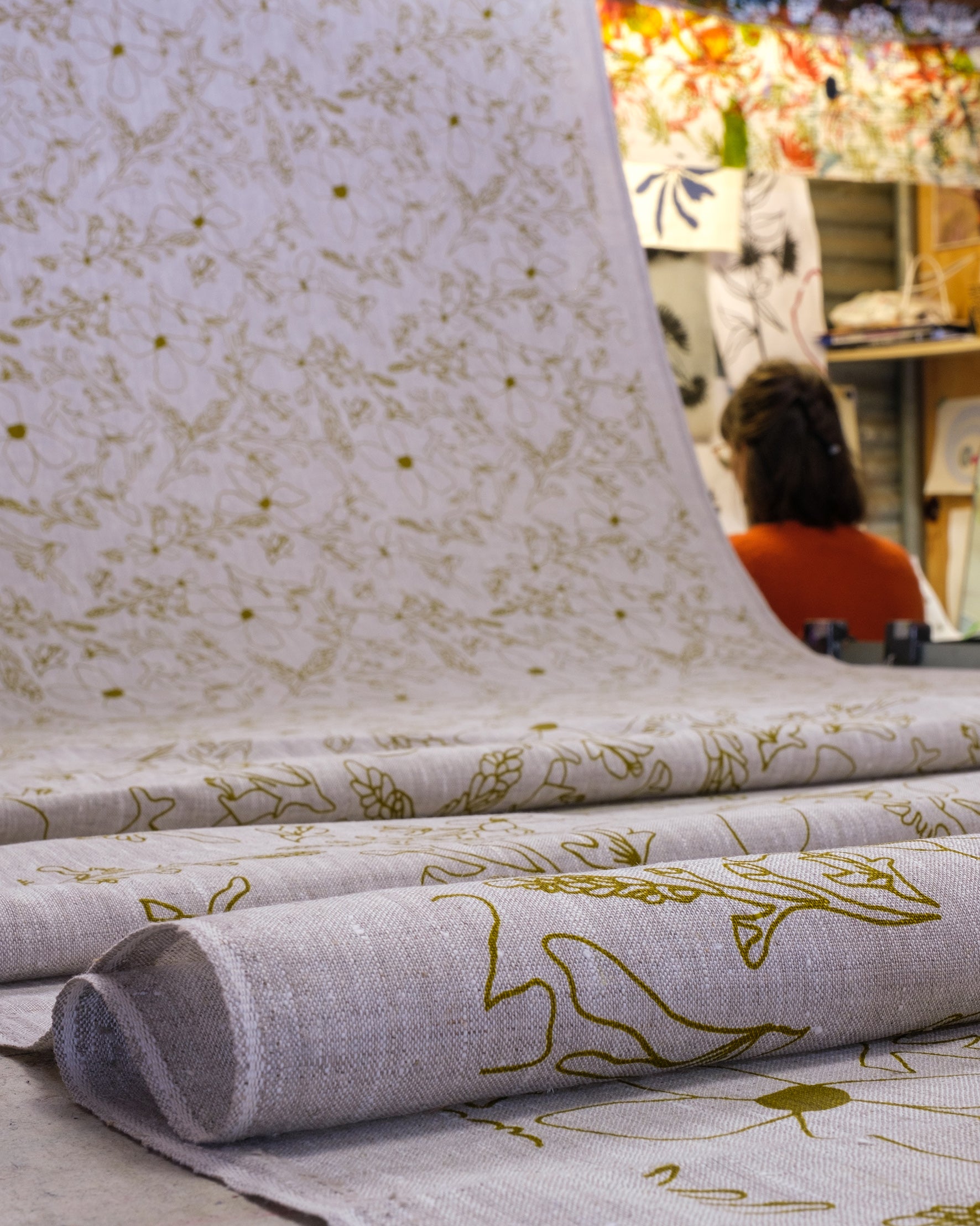 Screenprinted linen fabric with grass trigger pattern in olive oil. Designed and printed by Femke Textiles in Melbourne Australia.