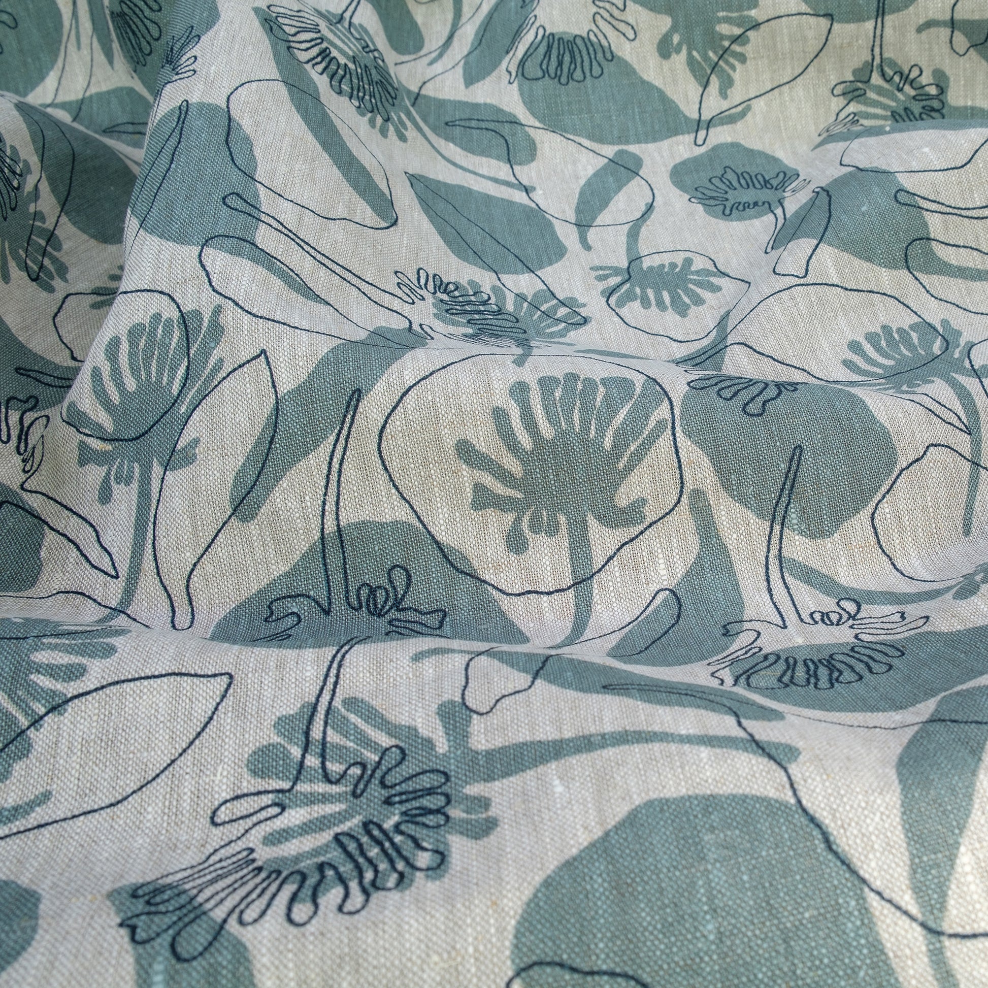 Linen fabric hand screenprinted with seedpods design in storm and indigo colour. Designed and printed by Femke Textiles. Basecloth is an oatmeal linen.