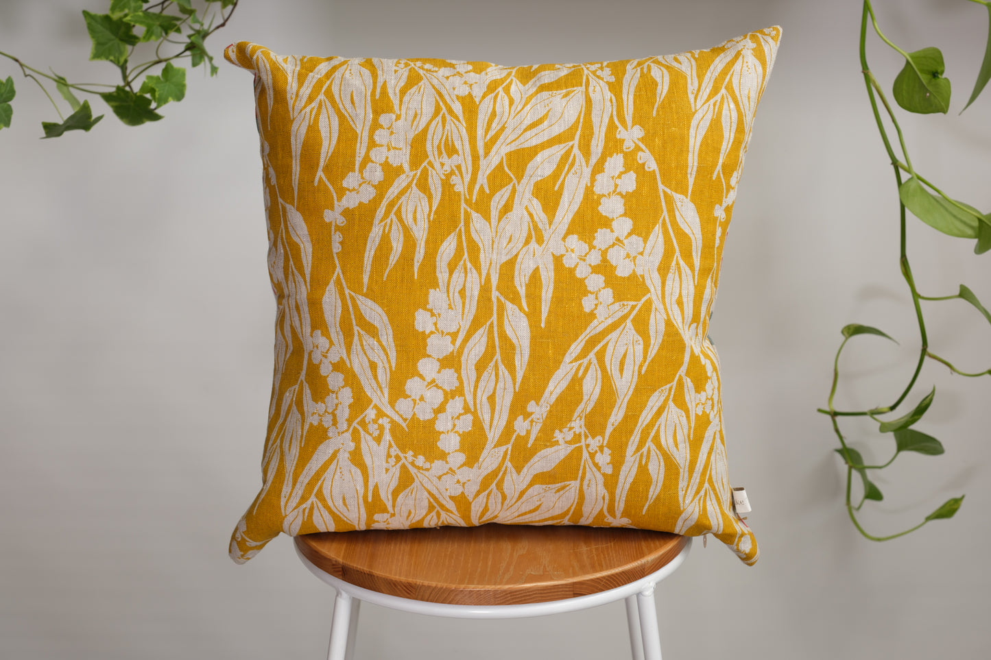 Linen cushion cover featuring hand screen printed wattle sprigs and nuts about wattle. Designed and made by Femke Textiles