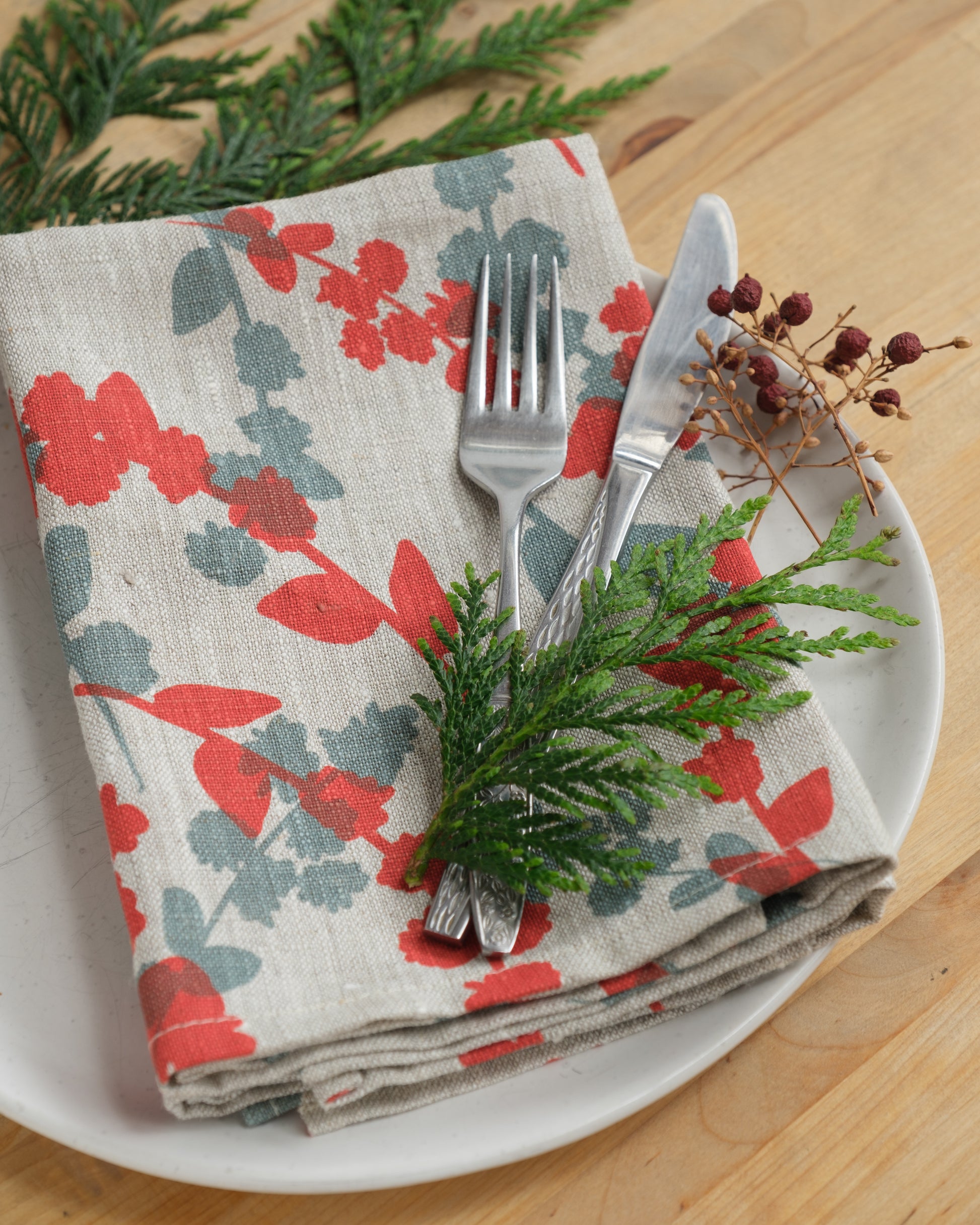 Linen napkins screen printed with Wattle Sprigs in Guava and Storm. Designed and screen printed by Femke Textiles.