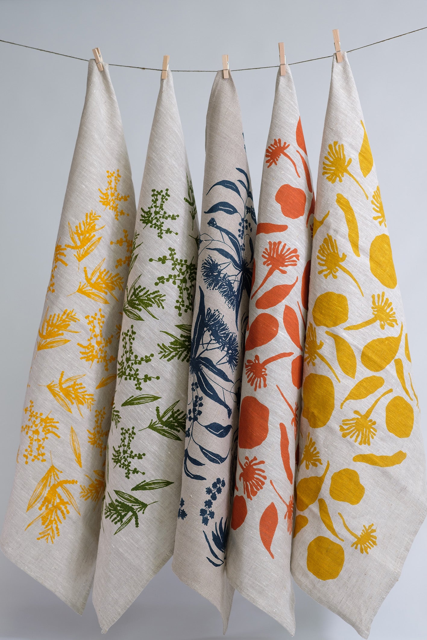 Linen tea towels screen printed with wattle design, mixed australian flora design and seed pods design. Screenprinted and designed by Femke Textiles