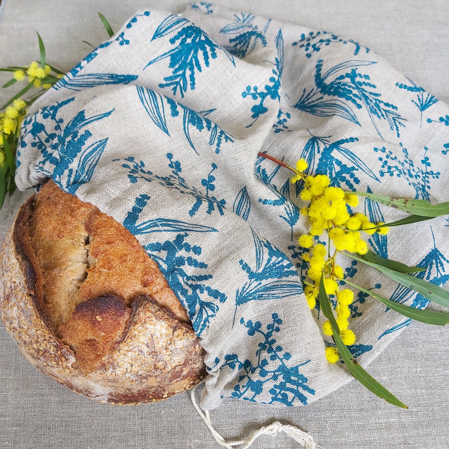 A linen breadbag screenprinted with mixed wattle pattern in sea blue on flax linen. Designed and printed by Femke Textiles.
