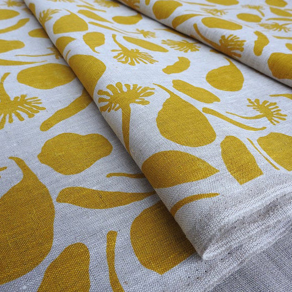 Linen fabric hand screen printed with seedpods design in a mustard colour. Printed and designed by Femke Textiles. Base cloth oatmeal linen.