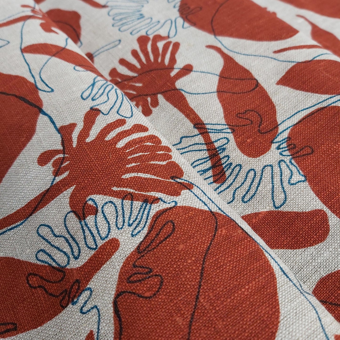 Linen oatmeal fabric screenprinted with seedpods design in redwood and sea blue. Printed and designed in Melbourne by textile designer Femke Textiles.